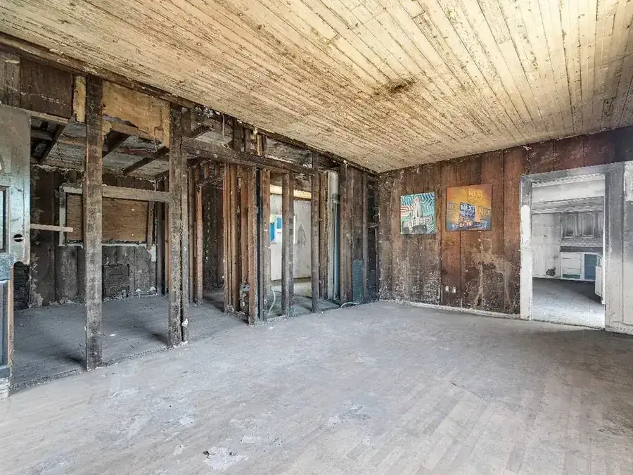 Interior gutted to the studs with exposed framing before renovation